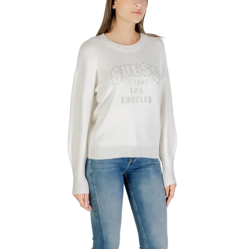 Women wearing Guess long-sleeved cream sweater with blue jeans, featuring a printed design