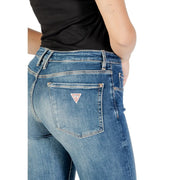 Back side of guess women’s blue denim jeans with a worn-out effect and red white triangular logo patch on pocket