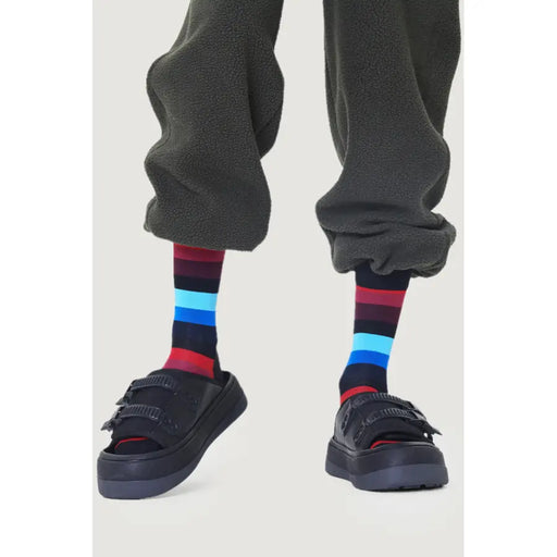Dark gray fleece sweatpants with colorful striped socks and black platform sandals for Men