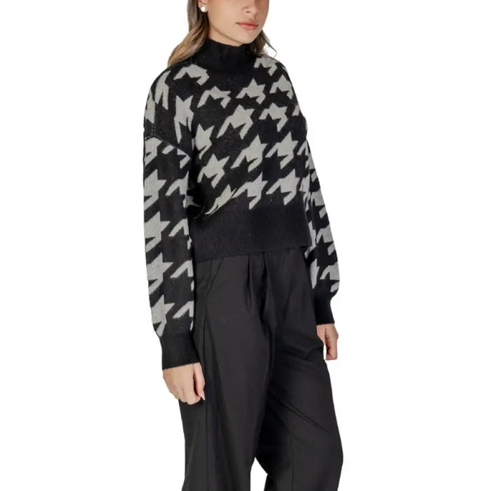 Women’s Houndstooth Turtleneck Sweater with Black Pants displayed in the product image