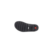 Back sole of hunter black rubber ankle boots for women showing textured tread pattern and red circular logo on heel