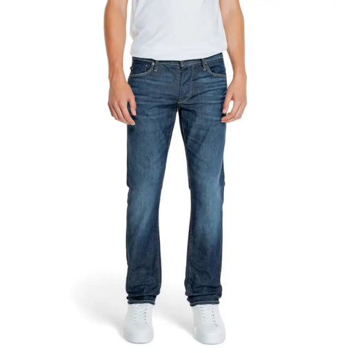Dark blue denim straight-leg jeans with distressed details and a popular brand logo on the back pocket.