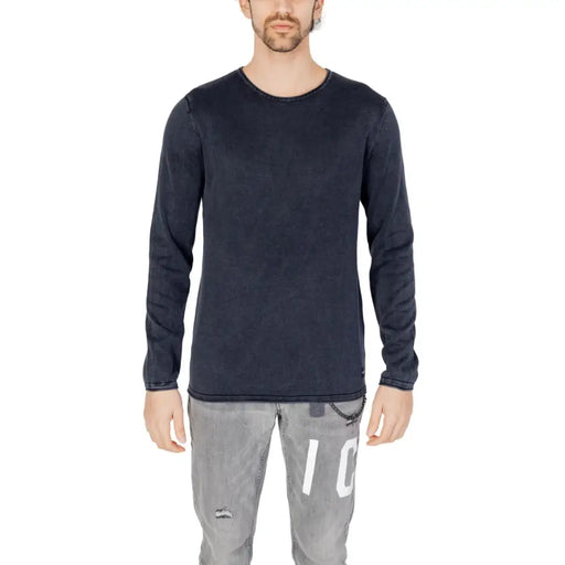 Dark navy long-sleeved cotton knit pullover with subtle texture and brand tag at hem by Jack and Jones for men