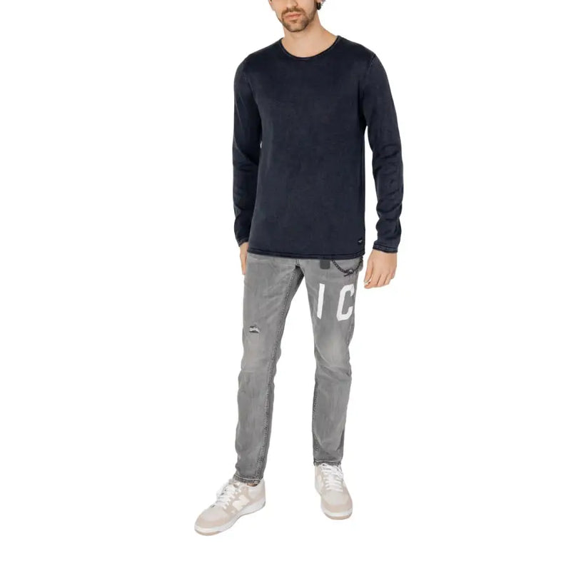 Dark navy long-sleeved cotton knit pullover with subtle texture and small jack & jones brand tag at the hem