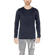 Dark navy long-sleeved cotton knit pullover with subtle texture and brand tag at hem by Jack and Jones for men