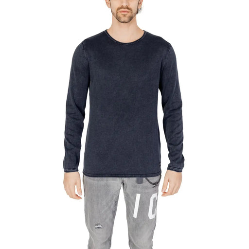 Dark navy long-sleeved cotton knit pullover with subtle texture and brand tag at hem by Jack and Jones for men