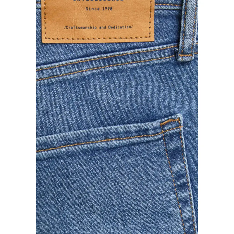 Jean en denim bleu Jack & Jones pour homme, effet usé, avec empiècement en cuir beige à l'arrière.