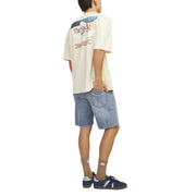 Back view of cream-colored short-sleeved t-shirt with graphic print paired with jack & jones light blue cotton polyester shorts for men