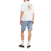 Back view of a white t-shirt with a detailed black and gray skull graphic paired with jack & jones men’s blue shorts