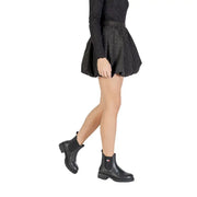Black leather chelsea boots with chunky sole and small flag emblem paired with jacqueline de yong black polka dot skirt