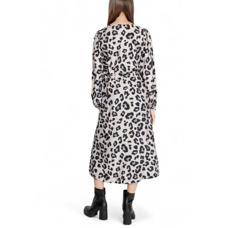 A woman wears a jacqueline de yong grey leopard long sleeve v neck knee-length dress with black and beige print