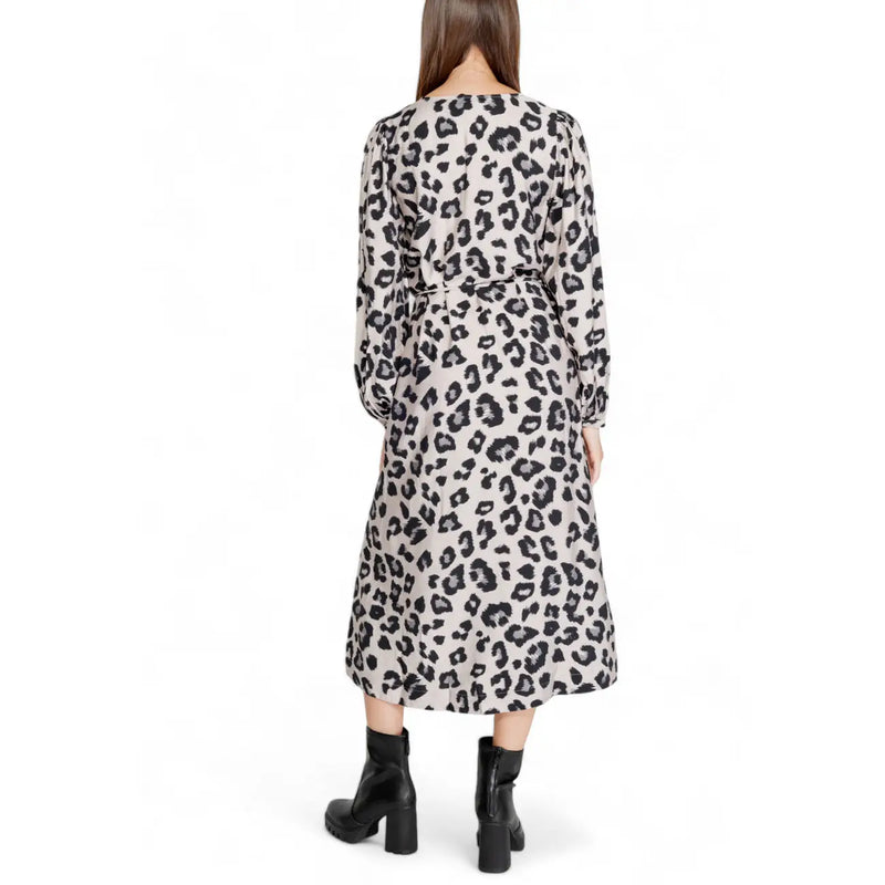 A woman wears a jacqueline de yong grey leopard long sleeve v neck knee-length dress with black and beige print