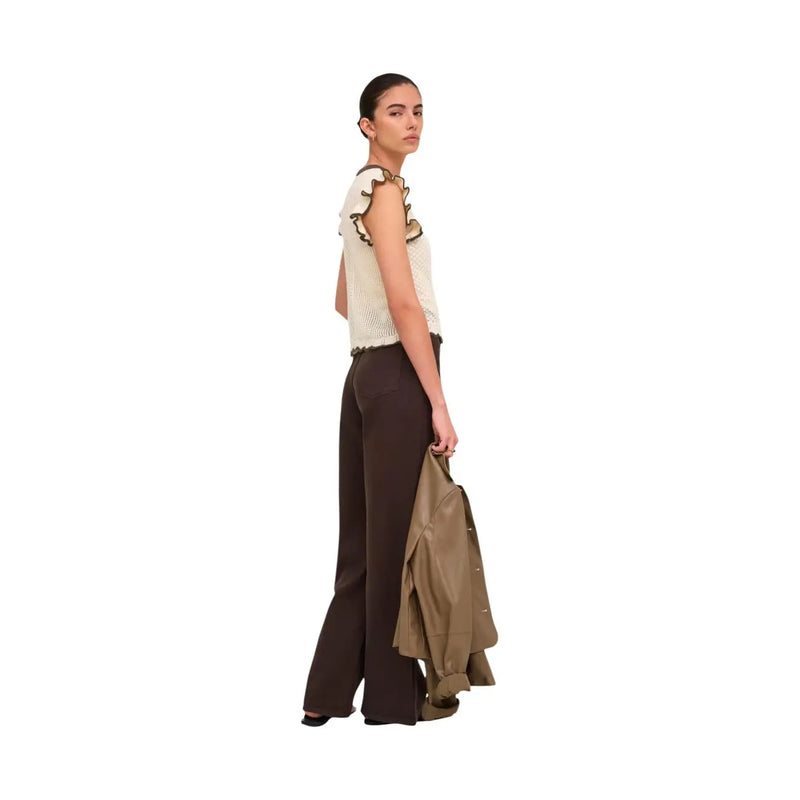 The model wears a jacqueline de yong beige sleeveless knit top with ruffled detailing in cotton fabric