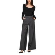 Women wearing Jacqueline De Yong black long-sleeve knit sweater with scalloped neckline and grey pinstripe wide-leg trousers