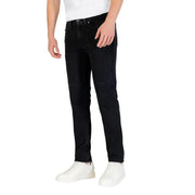 Black slim fit jeans with white laces on sneakers.