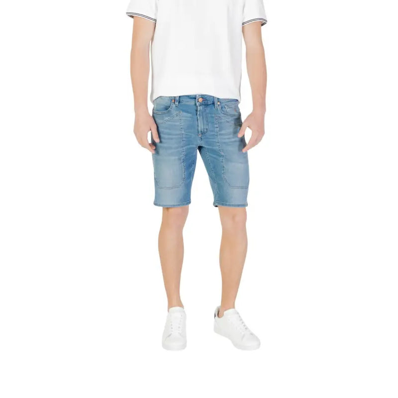 Blue denim shorts with rolled hem and white sneakers.
