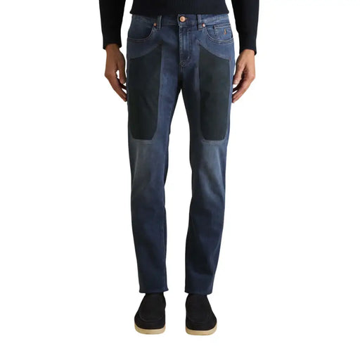 Dark blue jeans with patchwork design and reinforced knees, likely made of denim.
