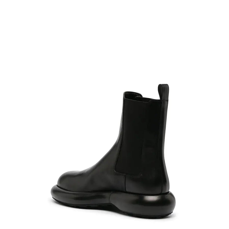 Bottines Chelsea pour homme en cuir noir Jil Sander, avec semelle épaisse en caoutchouc brillant et empiècements élastiques sur les côtés, collection automne-hiver