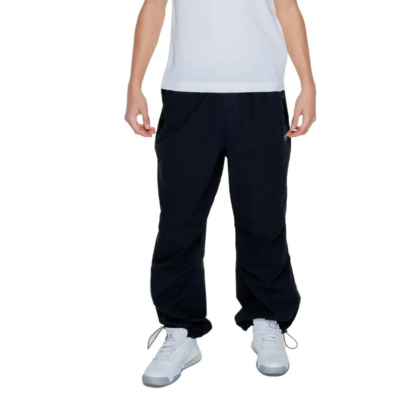 Karl kani mens black plain trousers 100 percent cotton with drawstring cuffs and side pockets front view