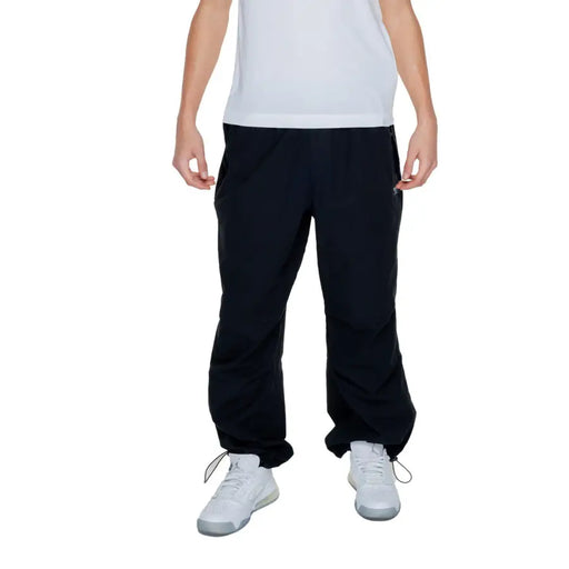 Karl kani mens black plain trousers 100 percent cotton with drawstring cuffs and side pockets front view