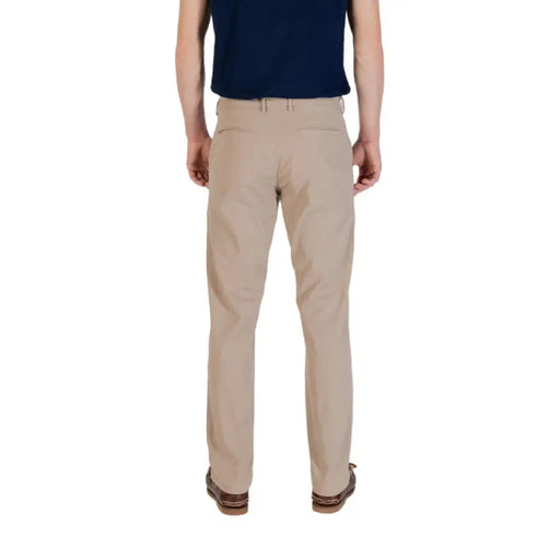 Khaki-colored men’s casual pants with brown boat shoes displayed for fashion styling