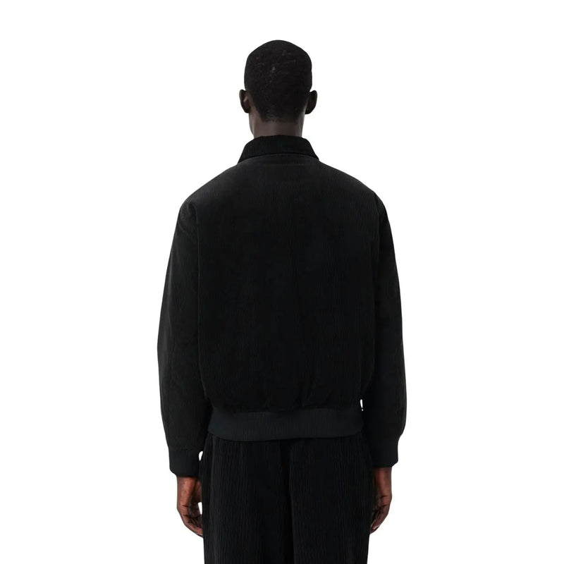 Blazer Lacoste pour homme en coton noir, style classique, composé d'une veste bomber en velours côtelé noir avec col et poignets côtelés.