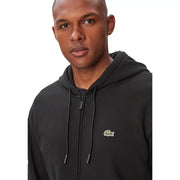 Sweat à capuche Lacoste pour homme, en coton noir, avec fermeture éclair sur le devant et logo crocodile vert sur la poitrine.