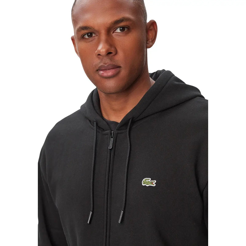 Sweat à capuche Lacoste pour homme, en coton noir, avec fermeture éclair sur le devant et logo crocodile vert sur la poitrine.