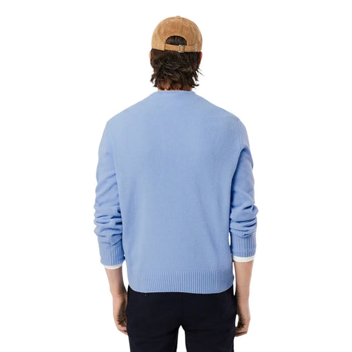 Lacoste men knitwear light blue round neck wool sweater with ribbed cuffs and hem paired with tan corduroy cap