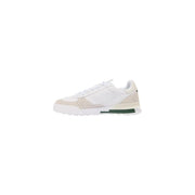 Baskets Lacoste pour homme en cuir blanc, modèle Slam Break, avec détails perforés et accent vert sur la semelle intermédiaire.
