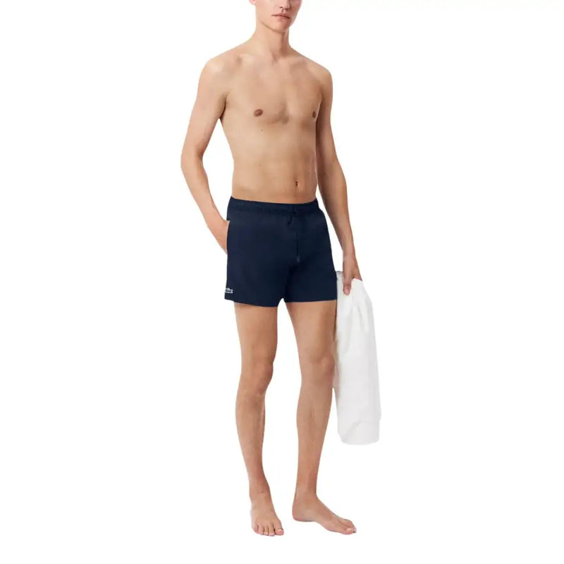 Navy blue lacoste men swimwear athletic swim trunks featuring a small logo on the left leg for swimming use