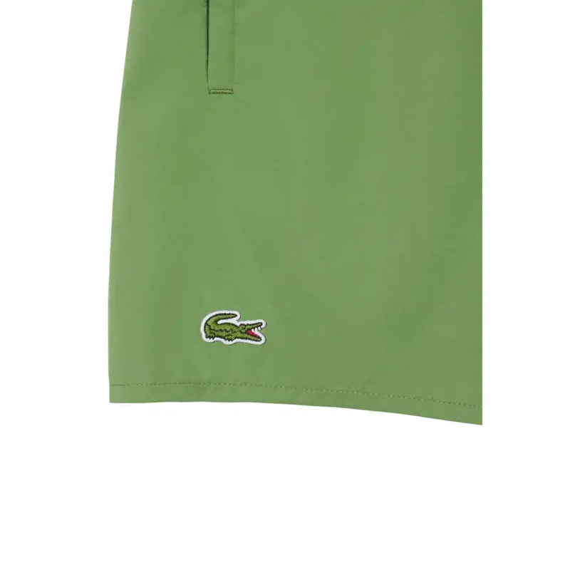 Green Lacoste men swimwear shorts featuring a classic embroidered crocodile logo on the lower leg