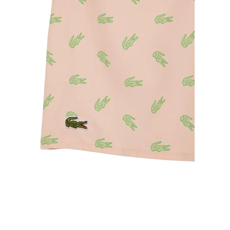 Pink Lacoste men swimwear shorts with repeating light green crocodile pattern and dark green embroidered logo