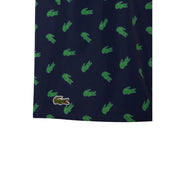 Dark blue Lacoste men swimwear shorts with green crocodile logo pattern and embroidered logo on lower left leg
