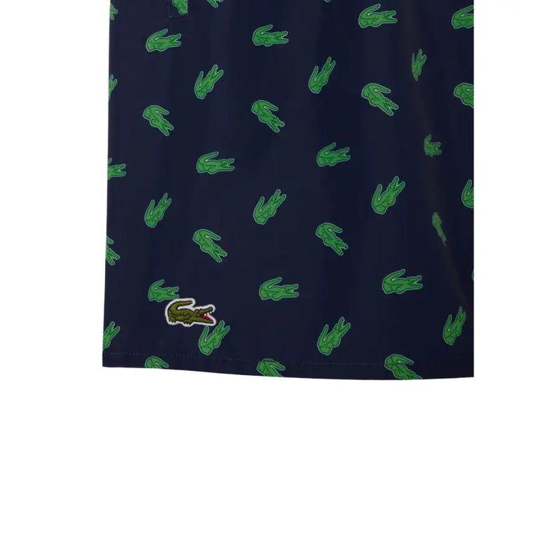 Dark blue Lacoste men swimwear shorts with green crocodile logo pattern and embroidered logo on lower left leg