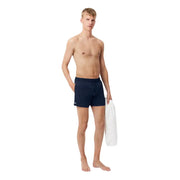 Navy blue Lacoste men swim trunks featuring a small logo on the left leg designed for swimwear use