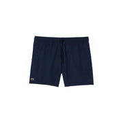 Navy blue Lacoste men swim trunks with subtle textured fabric and green crocodile logo on lower left leg