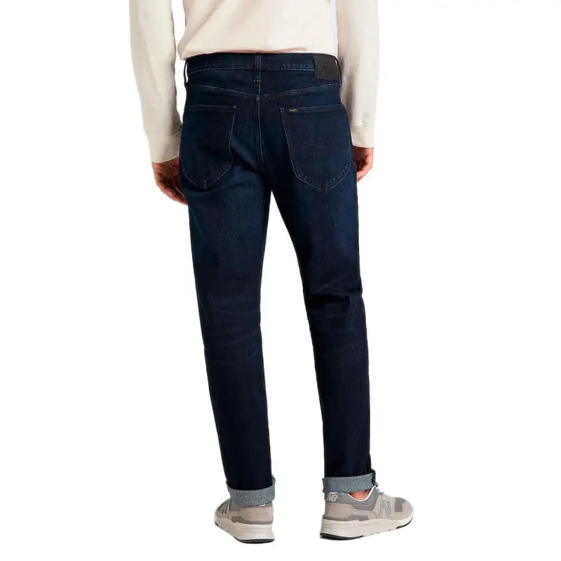 Lee men’s Austin blue jeans in dark indigo denim with slim fit and rolled cuffs featuring functional pockets