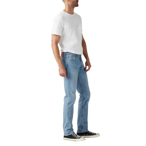 Light blue denim jeans with a classic straight leg fit and white stitching, possibly from levi’s 501 model.