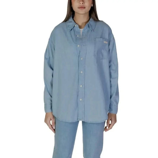 Light blue collared button-up shirt with long sleeves and chest pocket by Calvin Klein Jeans