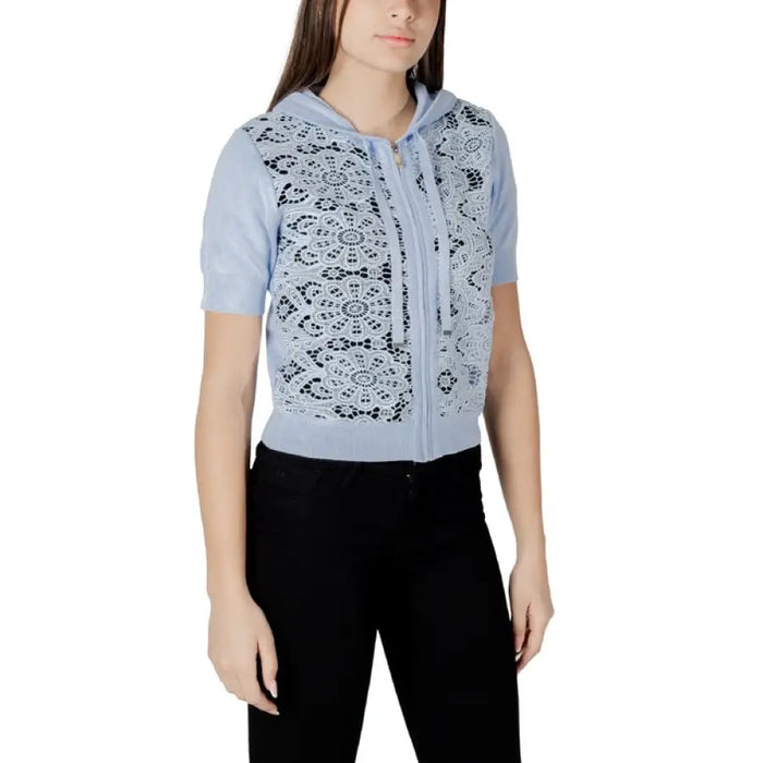 Light blue lace-front hooded cardigan paired with black pants displayed in the product image