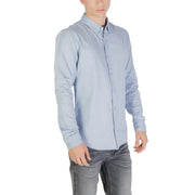 Light blue long sleeved shirt with classic collar and neatly pressed fabric for formal or casual wear