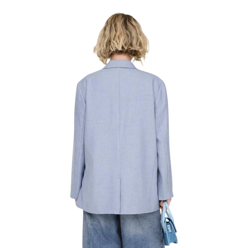 Light blue women’s oversized blazer with button front, structured shoulders, pockets, and a minimalist design