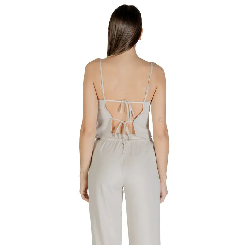 Light gray women’s jumpsuit with spaghetti straps and open tie-back detail for spring summer wear
