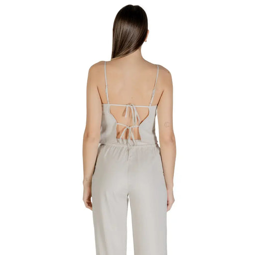 Light gray women’s jumpsuit with spaghetti straps and open tie-back detail for spring summer wear
