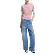 Light pink Desigual Women T-Shirt with rolled sleeves paired with light wash wide-leg jeans