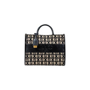 Black and beige patterned tote bag with top handle and decorative charm for Liu Jo handbag