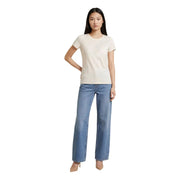 A woman wearing a liu jo women beige cotton round neck short t shirt with embroidered logo and light-wash jeans