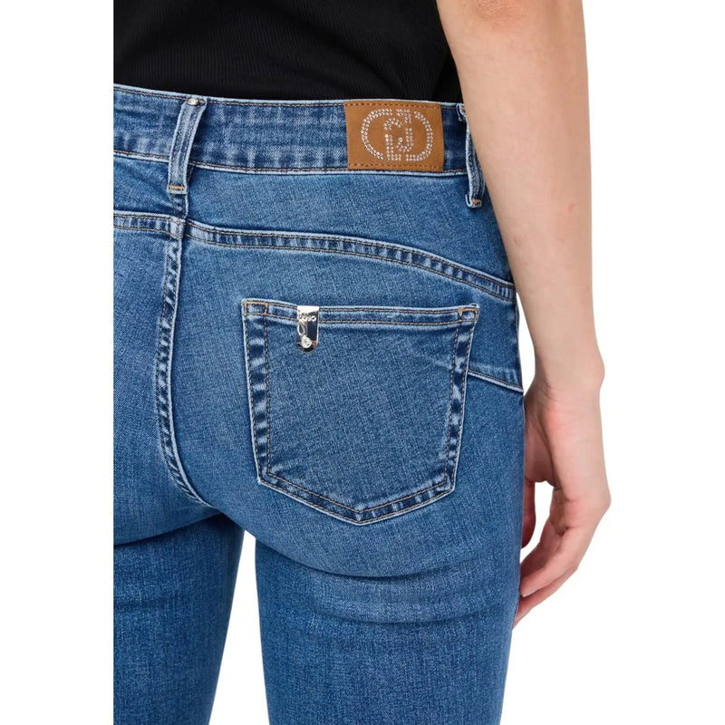 Back side of liu jo women’s blue cotton blend jeans featuring a brown leather patch with rhinestones and silver button