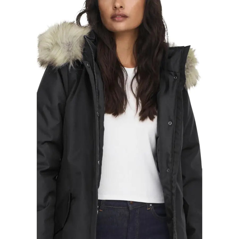 Long black hooded jacket for women featuring a zip and automatic buttons with plush beige fur-lined hood